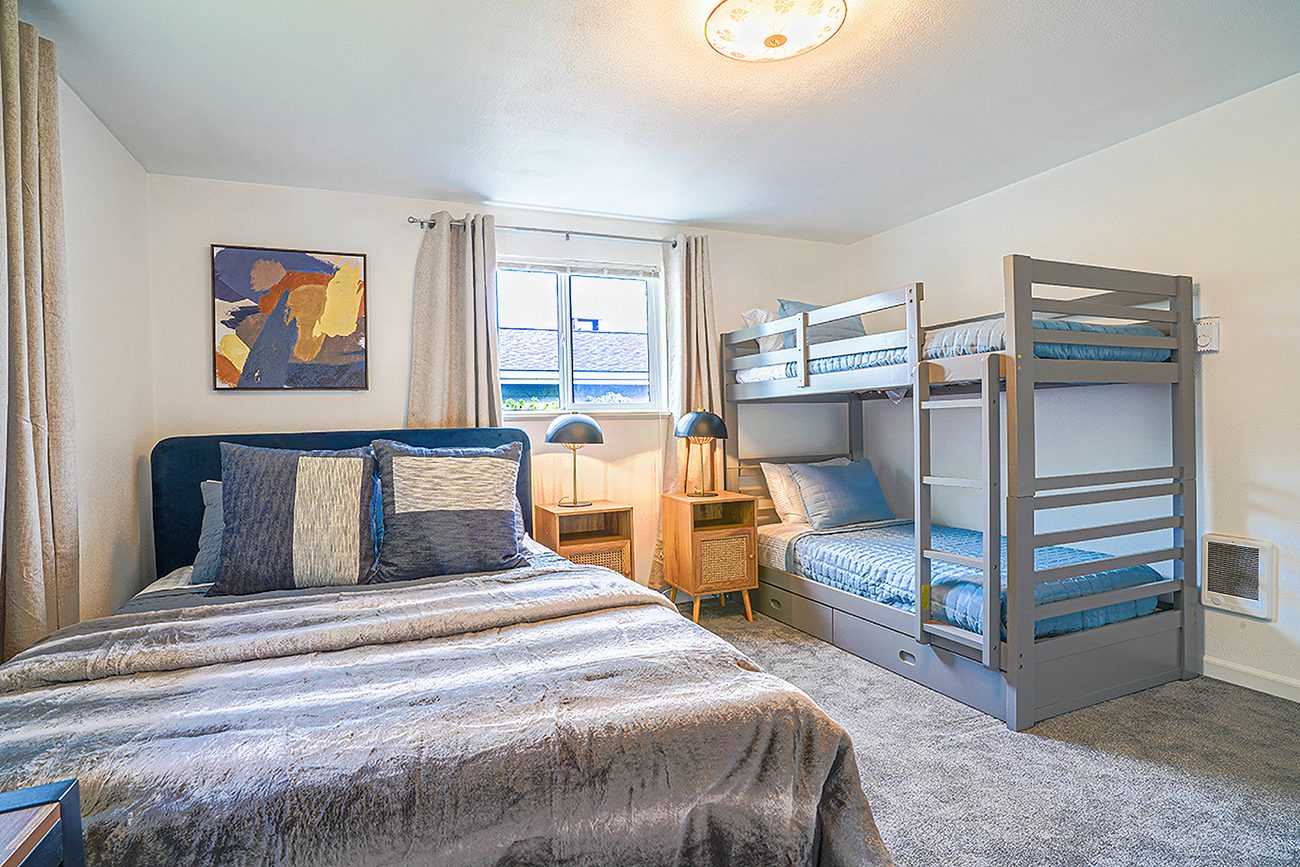 A guest-ready bedroom with the beds made and fresh linens, set for the next check-in